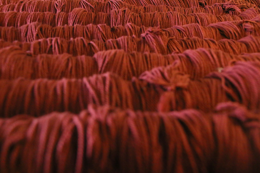 A large quantity of red drawstring fabric