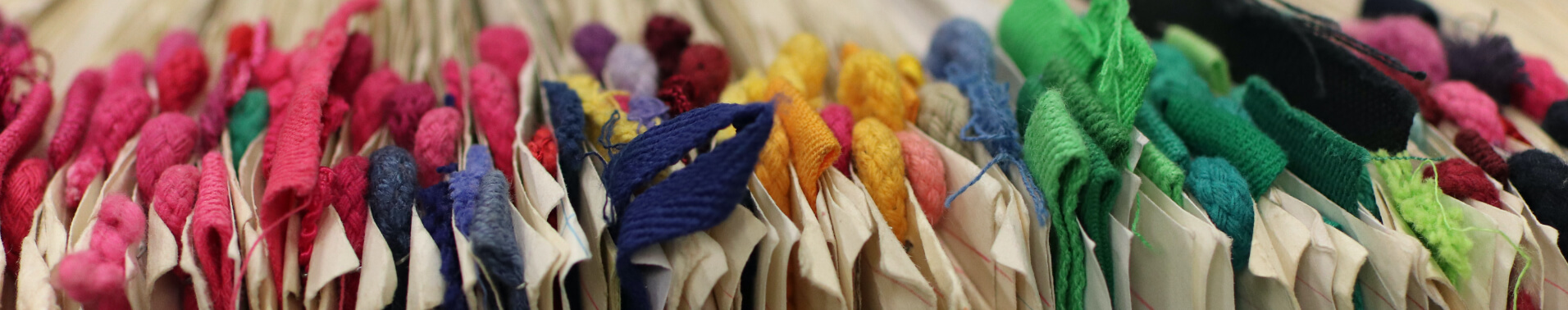 Pieces of dyed fabric organized by color